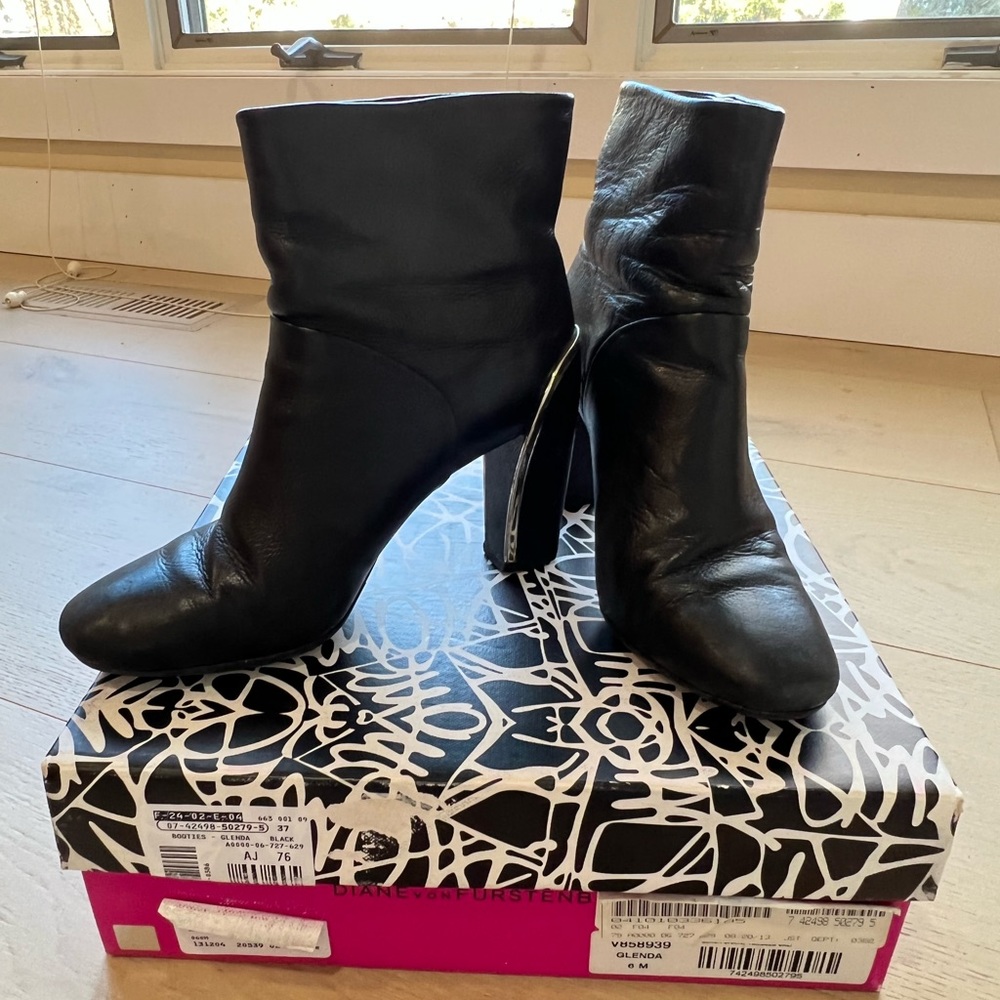 Diane Von Furstenberg Black Round Toe Genuine Leather Boot with gold trim.